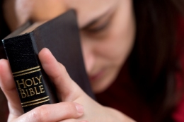 Praying woman with Bible